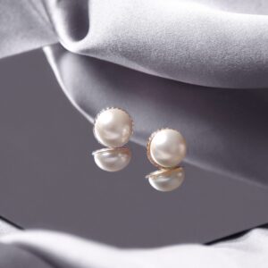 gold button pearl stud earrings styled on a reflective surface with a rope edge border