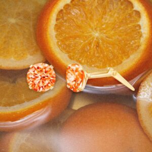 gold orange cz stud earrings styled with sliced oranges in a bright citrus flat lay