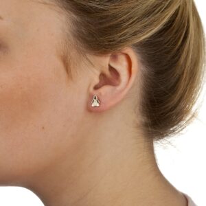 Gold enamel penguin stud earring worn on ear