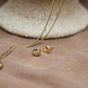 Gold sunburst stud earrings measuring approx. 6mm diameter