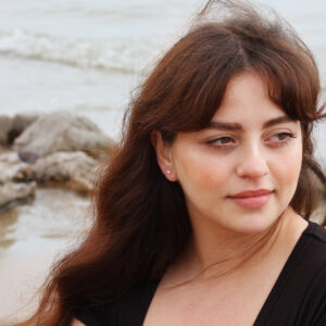 gold 5mm pearl stud earrings worn on the ear with a classic pearl look