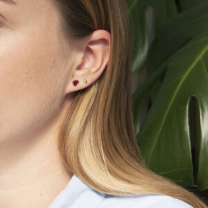 dark red heart studs pair with rich red sparkle and polished gold setting